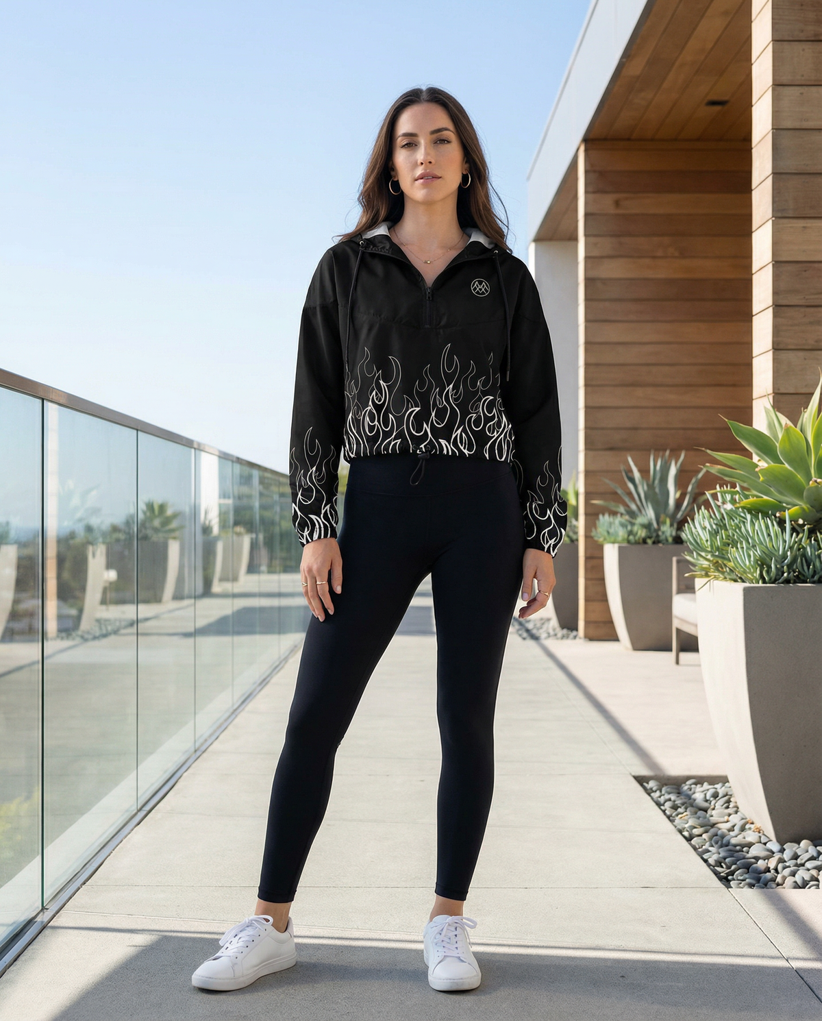 Woman wearing black cropped windbreaker with white flame print