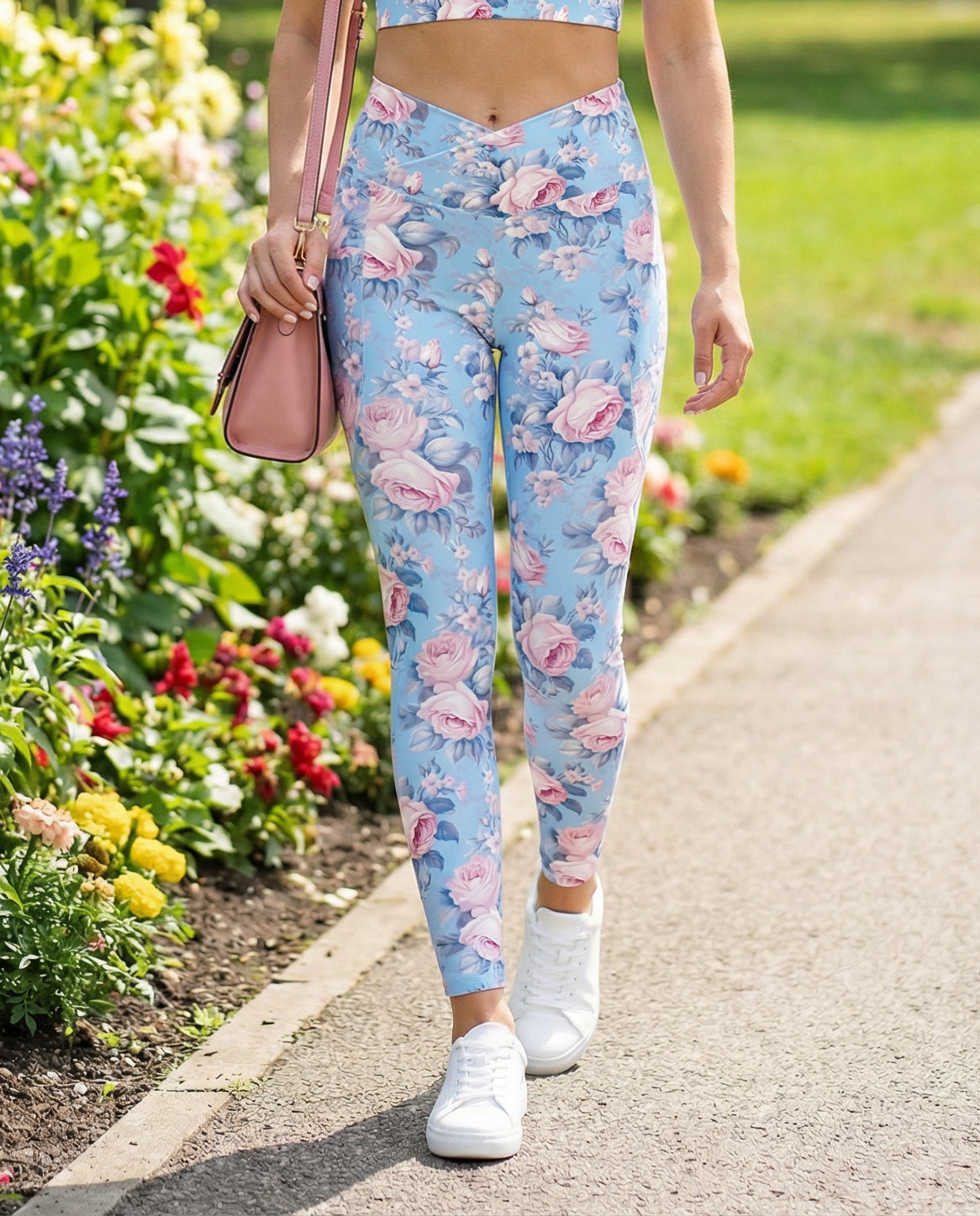 woman wearing powder blue crossover leggings with side pockets with pink rose floral feminine botanical pattern showing the front
