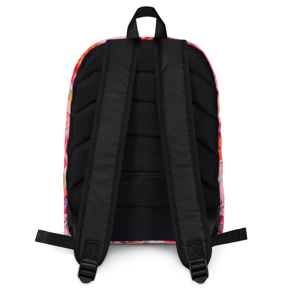 baby pink backpack with multicolor and red botanical floral feminine pattern and black straps and handle with hidden zipper pocket and plastic strap adjustments back view