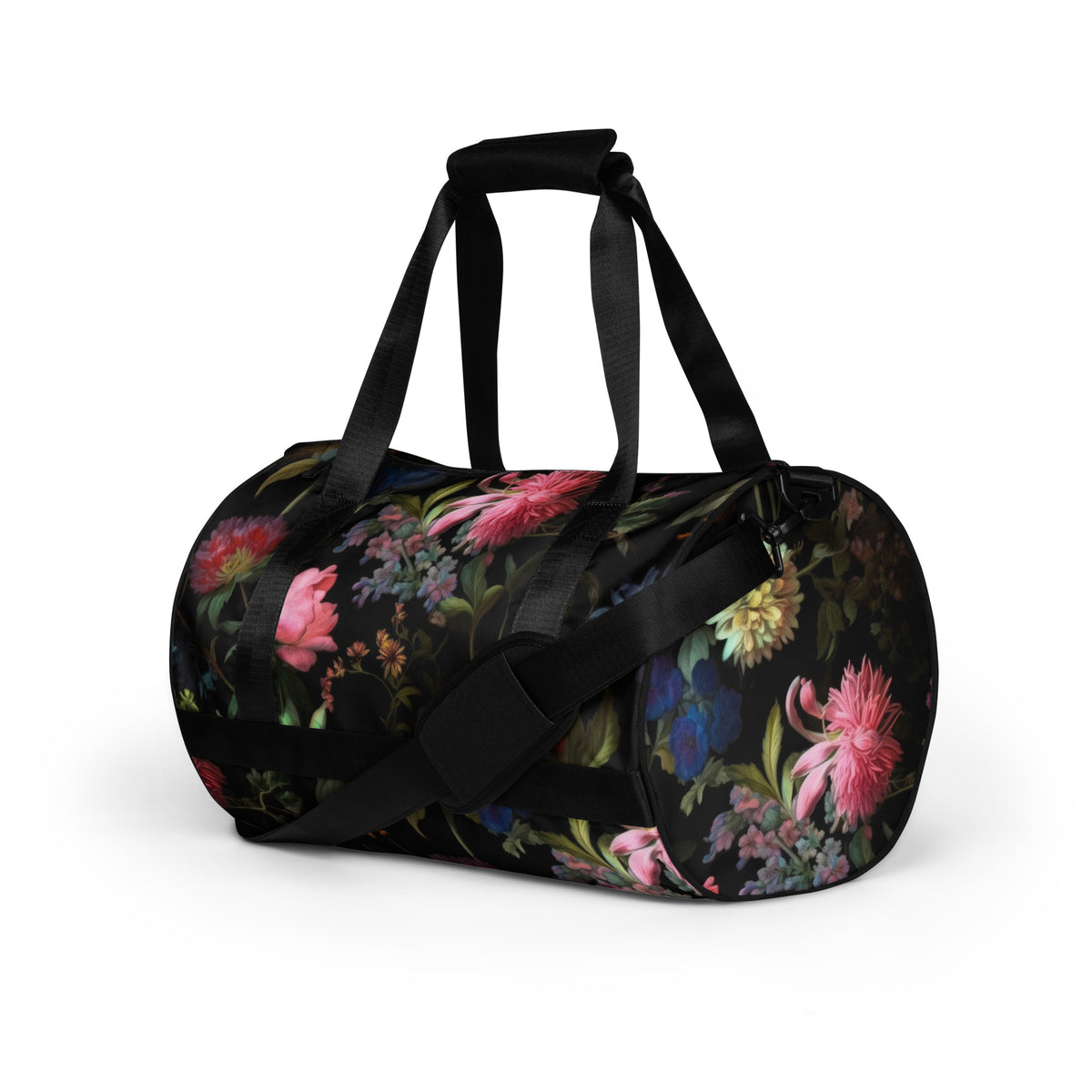 Gym duffle bag with zipper and black straps and black removable shoulder strap in black with a colorful red blue and pink floral botanical feminine pattern showing an angled view