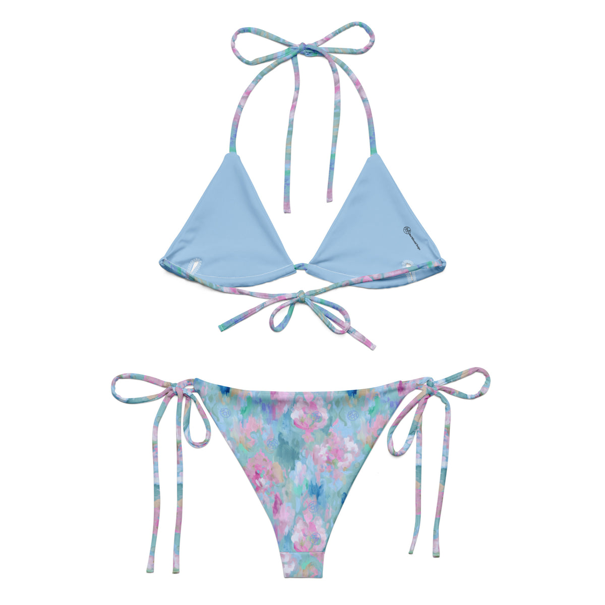 powder blue string bikini with abstract pattern of pastel pink beige blue and teal showing the back