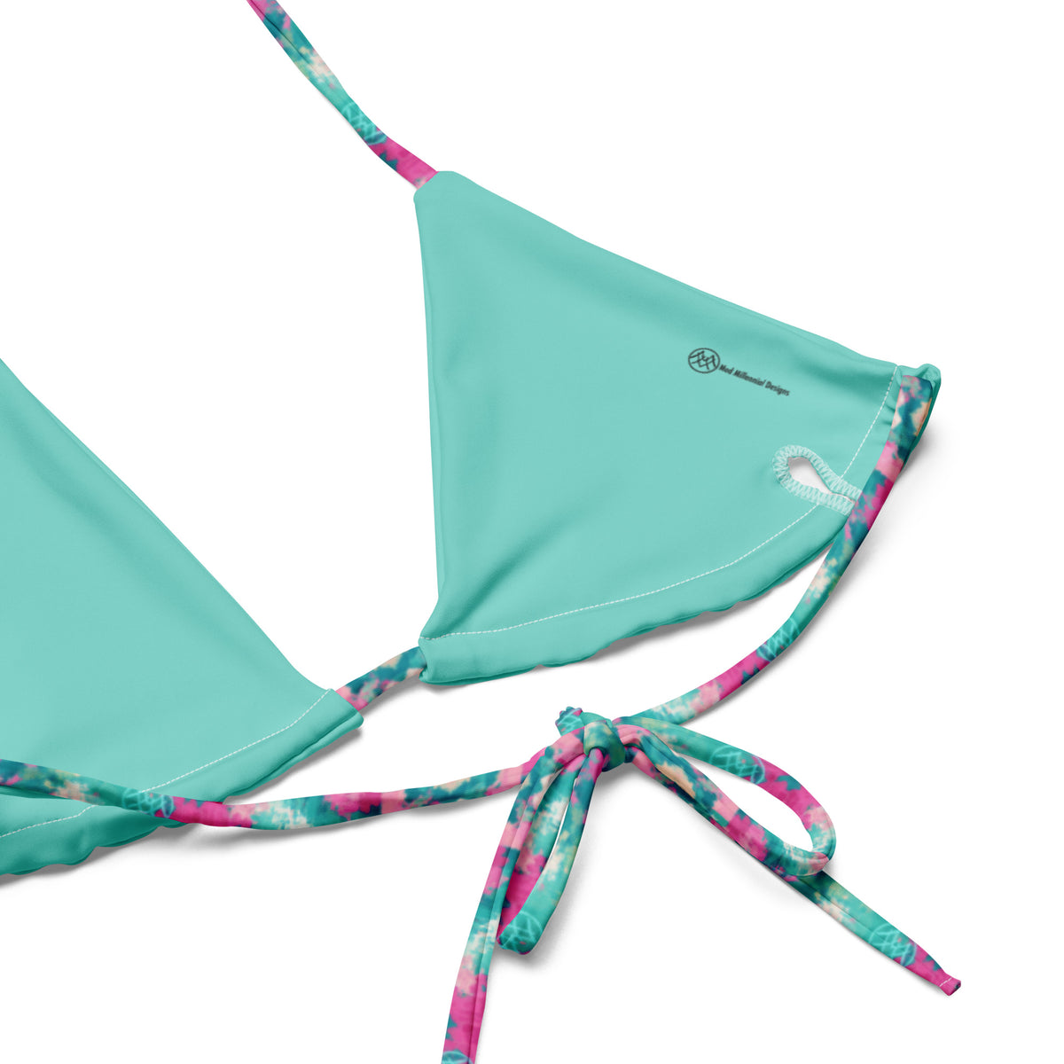 white string bikini with geometric turquoise and magenta pattern showing the inner lining and the adjustable ties