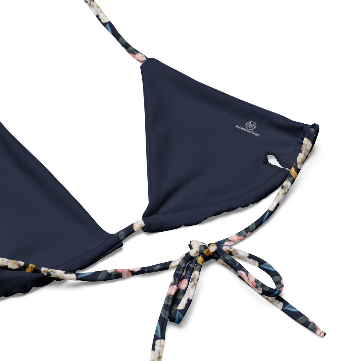 navy blue string bikini with yellow and pink feminine floral pattern on it close-up view showing inside lining details and adjustable ties