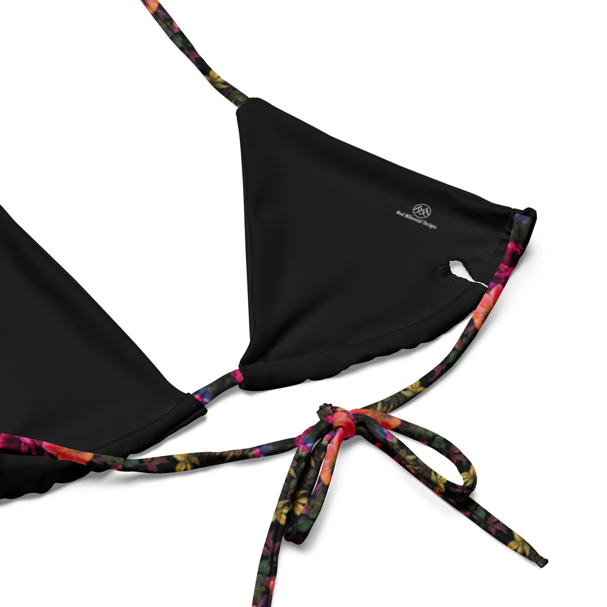 black string bikini with vibrant colorful pink yellow and green feminine floral botanical pattern showing a close-up of the inner lining and adjustable ties