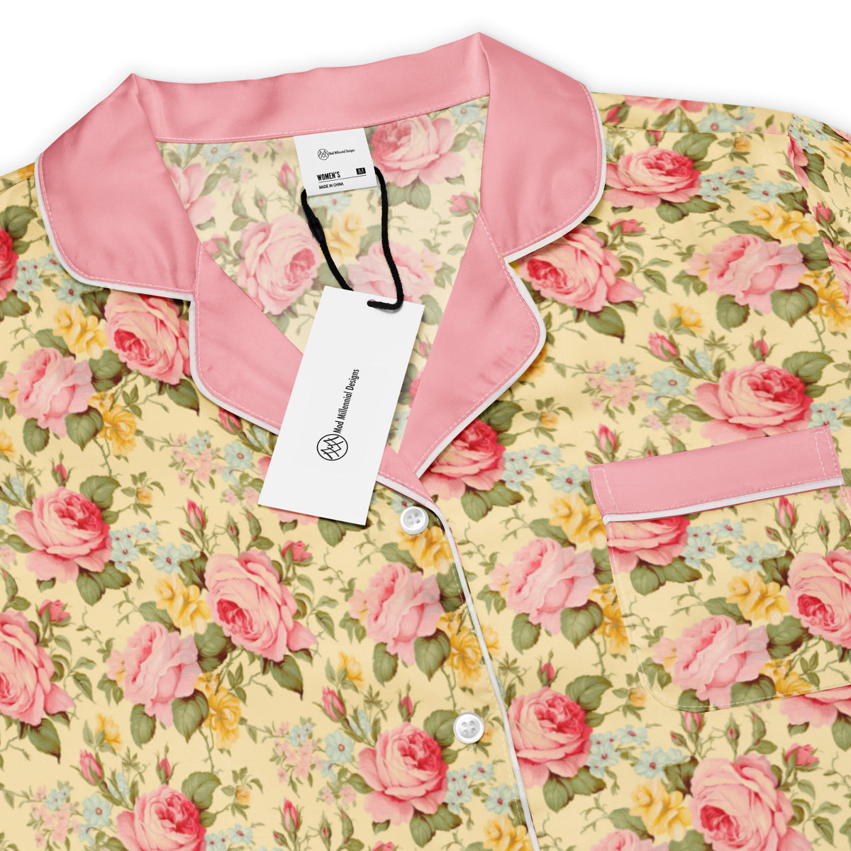short sleeve button down yellow pajama shirt with pink collar with light pink dark pink yellow and blue roses pattern showing the front details of the collar and pocket